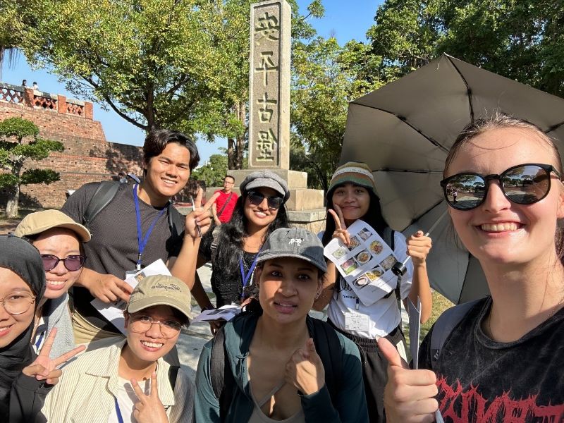 圖：外籍生展開笑顏與地標合影。（照片由語言中心提供）
