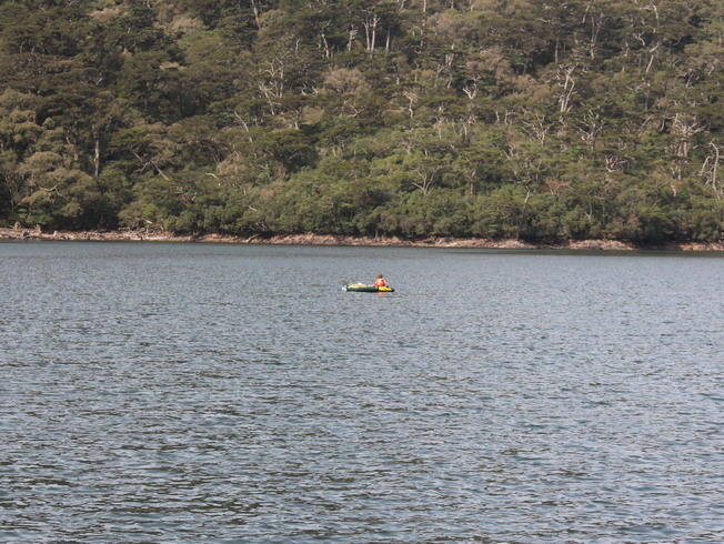 The researchers sat on the rubber boat, measuring the water depth of Daguei Lake with sonar.